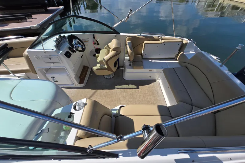 Slide: The Image of 2020 NauticStar 223 DC boat interior with beige seating and steering console. - 1