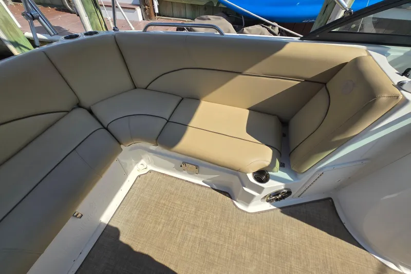 Slide: The Image of 2020 NauticStar 223 DC boat interior with beige cushioned seating. - 14