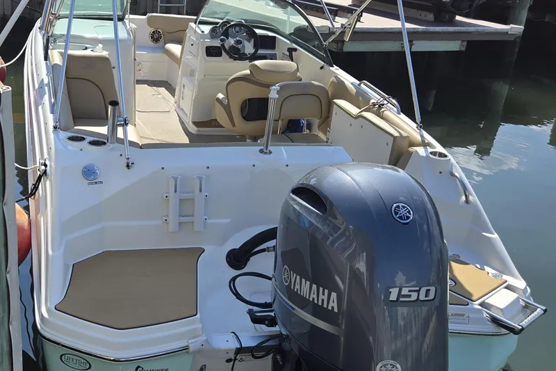 Slide: The Image of 2020 NauticStar 223 DC boat with Yamaha 150 engine, docked in marina. - 5