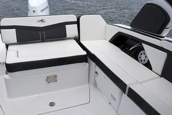 Slide: The Image of Manufacturer Provided Image: 2021 Monterey 255SS Super Sport boat interior with white and black seating, on water. - 11