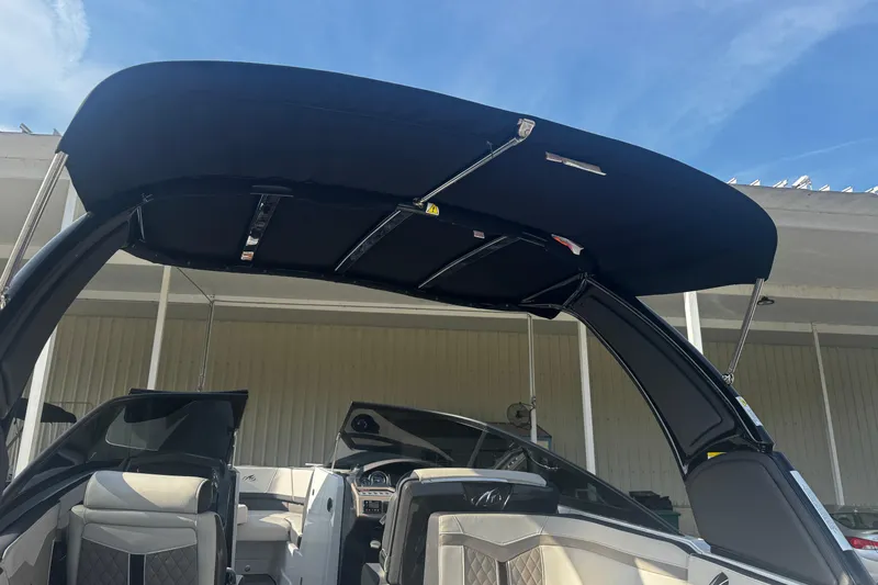 Slide: The Image of 2021 Monterey 255SS Super Sport boat interior with black canopy and modern seating. - 21