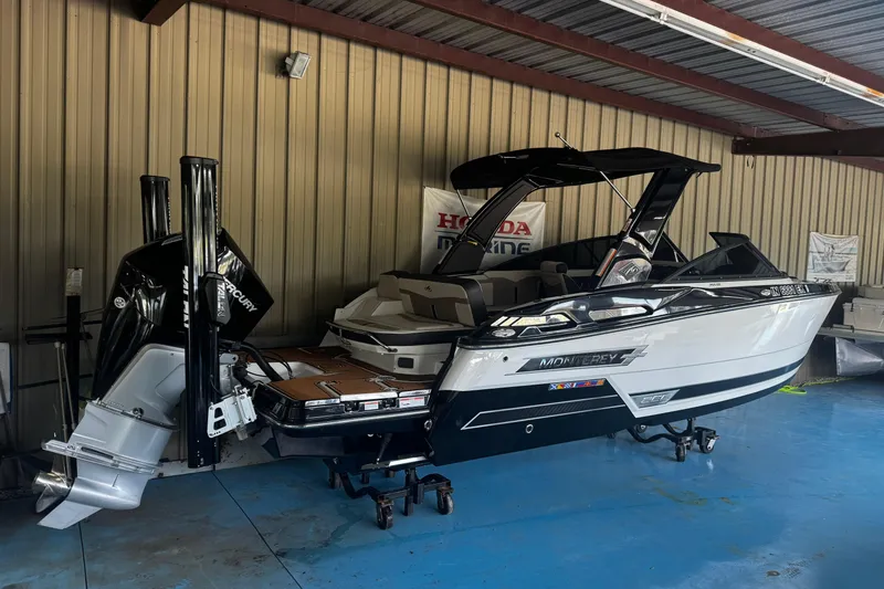 Slide: The Image of 2021 Monterey 255SS Super Sport boat in a garage, featuring a sleek design and powerful engine. - 24