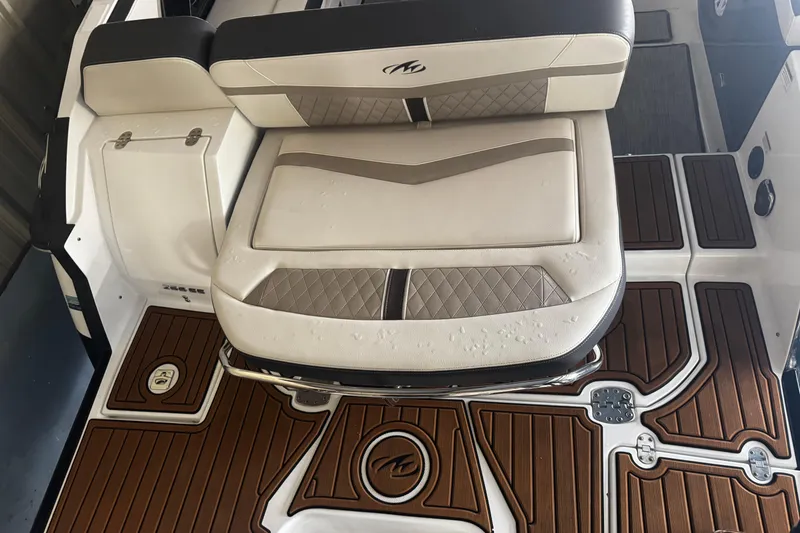 Slide: The Image of 2021 Monterey 255SS Super Sport boat interior with cushioned seating and stylish flooring. - 29