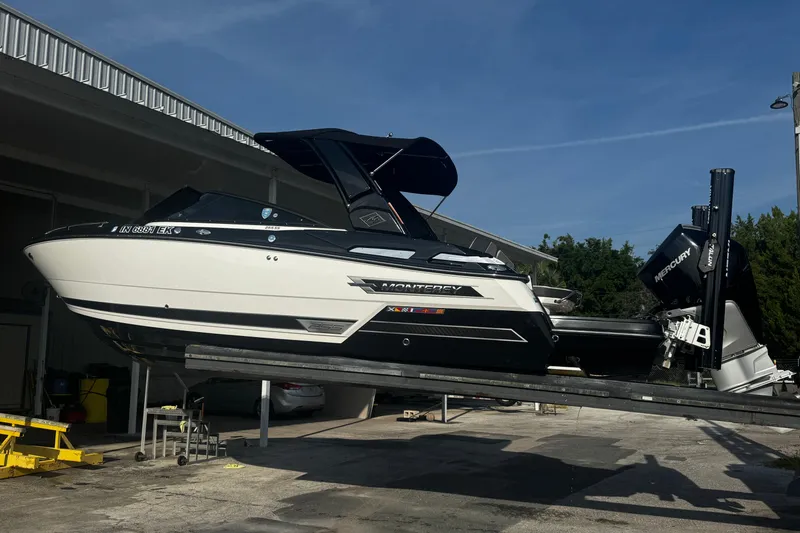 Slide: The Image of 2021 Monterey 255SS Super Sport boat on a lift, featuring sleek design and Mercury engine. - 4