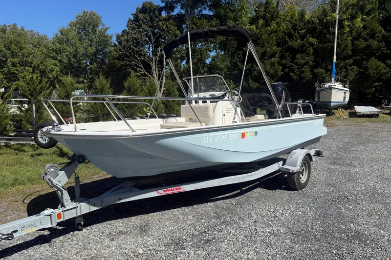 Slide: The Image of 2020 Boston Whaler 170 Montauk boat on trailer, parked outdoors. - 2