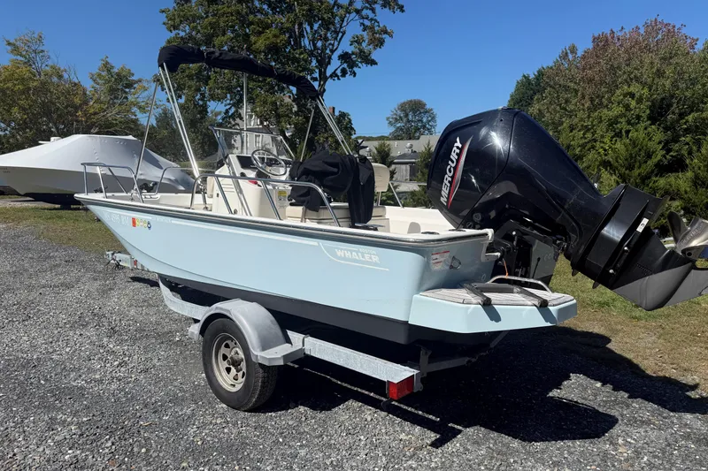 Slide: The Image of 2020 Boston Whaler 170 Montauk boat on trailer with Mercury outboard motor. - 3