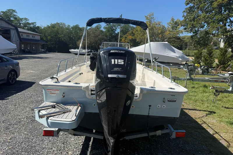 Slide: The Image of 2020 Boston Whaler 170 Montauk boat with Mercury 115 engine, parked outdoors. - 6