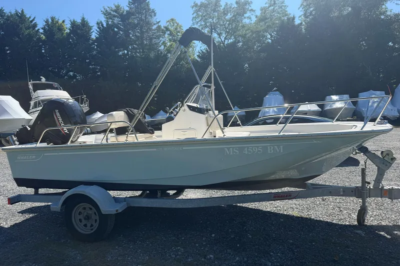 Slide: The Image of 2020 Boston Whaler 170 Montauk boat on trailer, parked outdoors. - 7