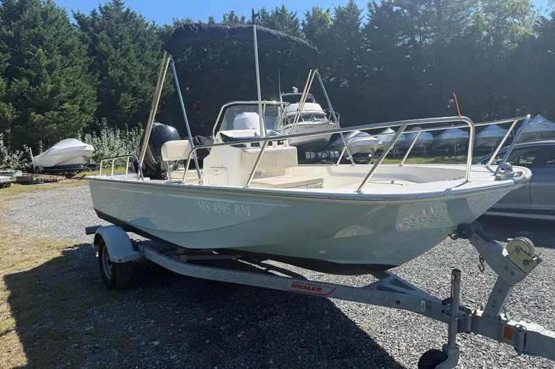 Slide: The Image of 2020 Boston Whaler 170 Montauk boat on trailer, parked outdoors. - 8