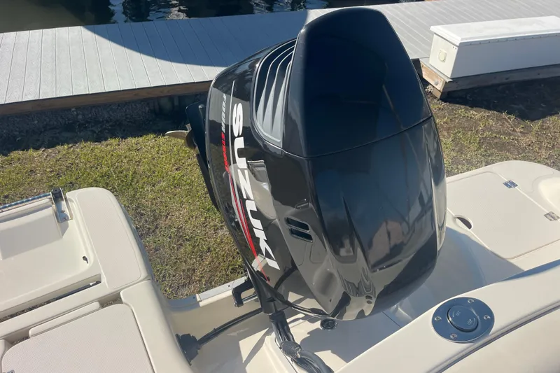 Slide: The Image of 2006 Hurricane FunDeck GS 202 OB with Suzuki outboard motor by a dock. - 10