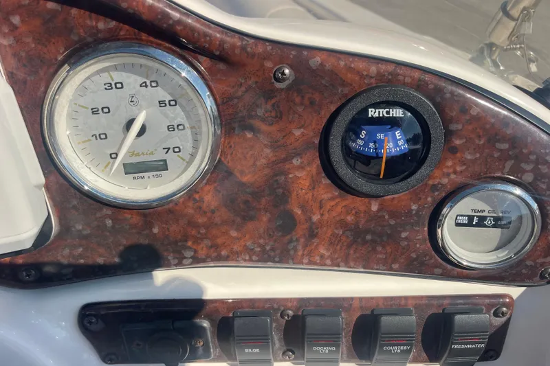Slide: The Image of Dashboard of 2006 Hurricane FunDeck GS 202 OB with gauges and switches. - 16