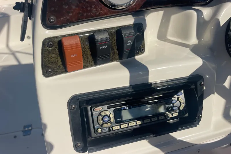 Slide: The Image of Control panel of 2006 Hurricane FunDeck GS 202 OB with switches and Jensen stereo. - 18