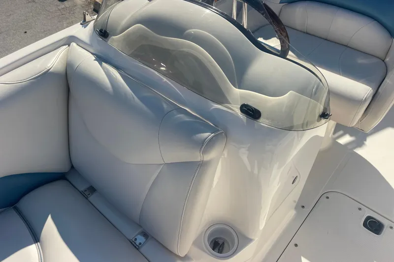 Slide: The Image of 2006 Hurricane FunDeck GS 202 OB boat interior with white seating and steering console. - 27