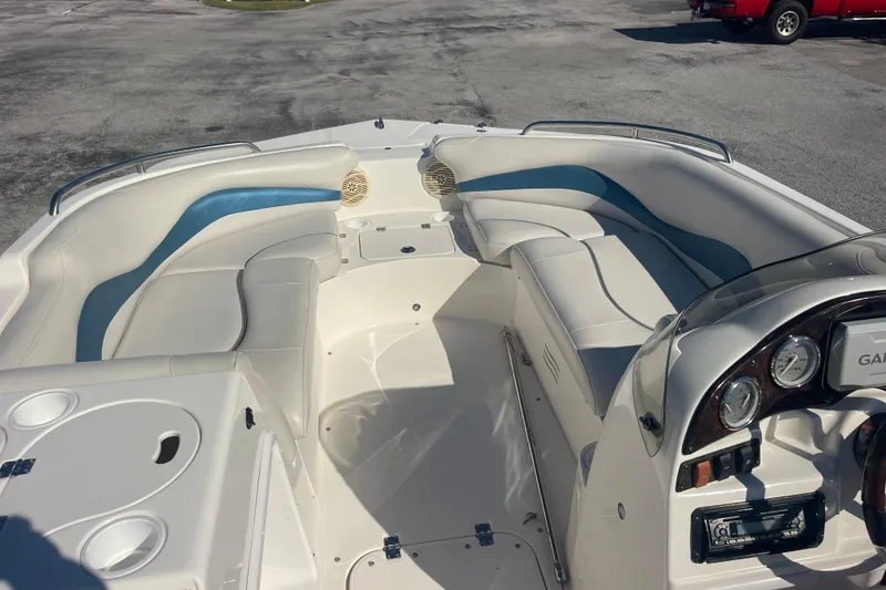 Slide: The Image of 2006 Hurricane FunDeck GS 202 OB boat interior with white and blue seating, dashboard, and cup holders. - 36
