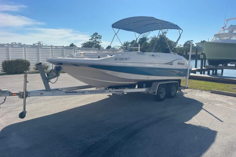 Slide: The Image of 2006 Hurricane FunDeck GS 202 OB boat on trailer, parked near waterfront. - 4
