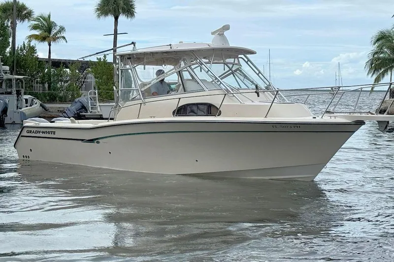 The Image of 2012 Grady-White Marlin 300 boat docked in tropical waters with palm trees. - 0