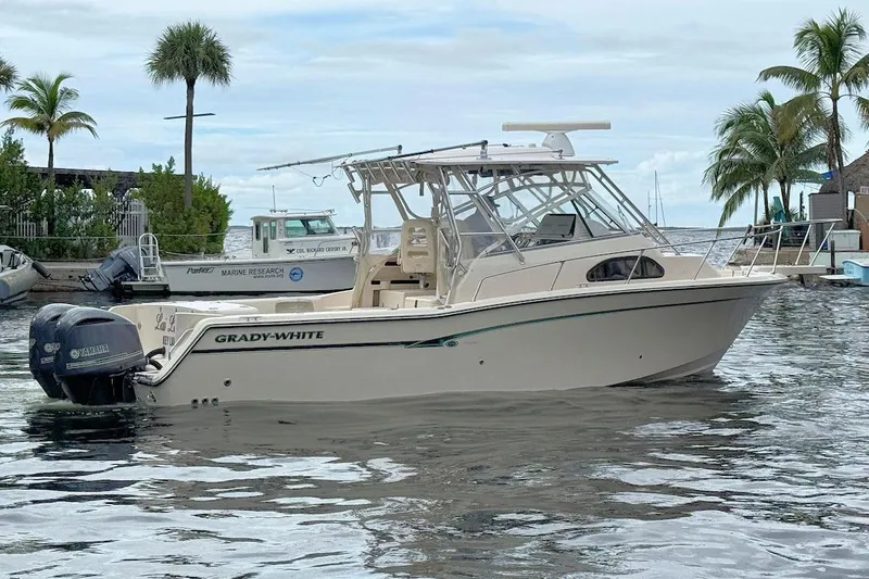 Slide: The Image of 2012 Grady-White Marlin 300 boat docked in tropical marina setting. - 1