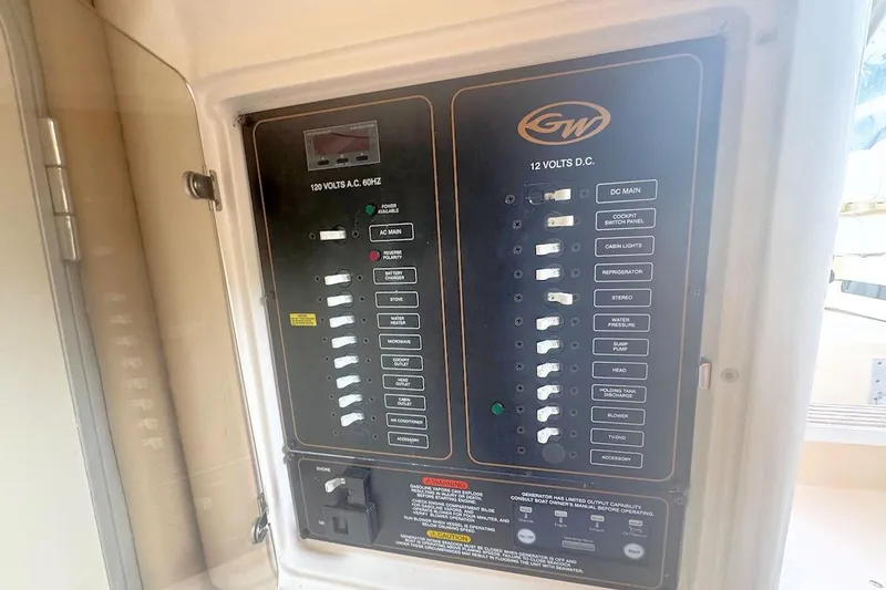 Slide: The Image of Electrical panel of 2012 Grady-White Marlin 300 boat, showing AC and DC switches. - 11