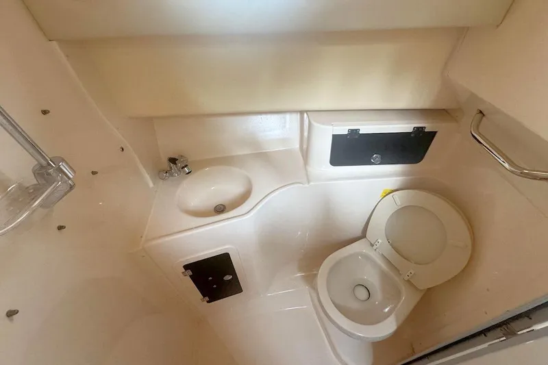 Slide: The Image of 2012 Grady-White Marlin 300 boat bathroom with sink and toilet. - 12