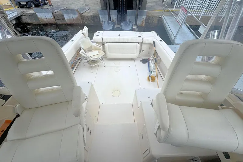 Slide: The Image of 2012 Grady-White Marlin 300 boat interior with white seating and spacious deck. - 6