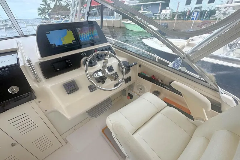 Slide: The Image of Interior view of 2012 Grady-White Marlin 300 boat cockpit with navigation screens. - 8