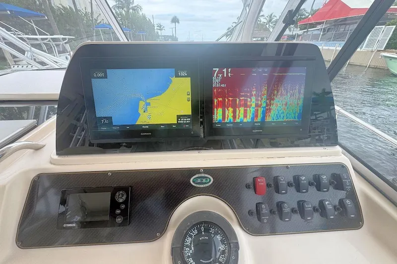 Slide: The Image of Dashboard of a 2012 Grady-White Marlin 300 boat with navigation screens. - 9