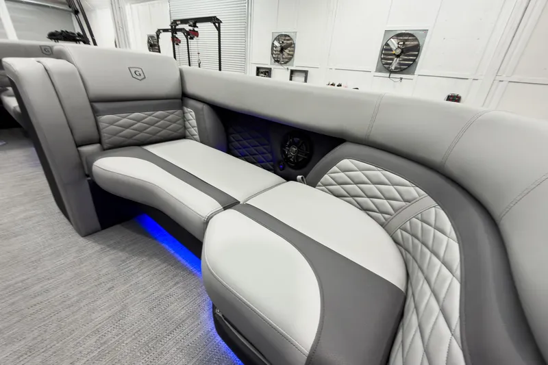Slide: The Image of Luxurious interior of 2026 Godfrey Monaco 23' Tritoon with elegant gray seating and blue LED lighting. - 19