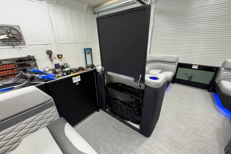 Slide: The Image of 2026 Godfrey Monaco 23' Tritoon interior with flip lounge, modern seating, and ambient lighting. - 29