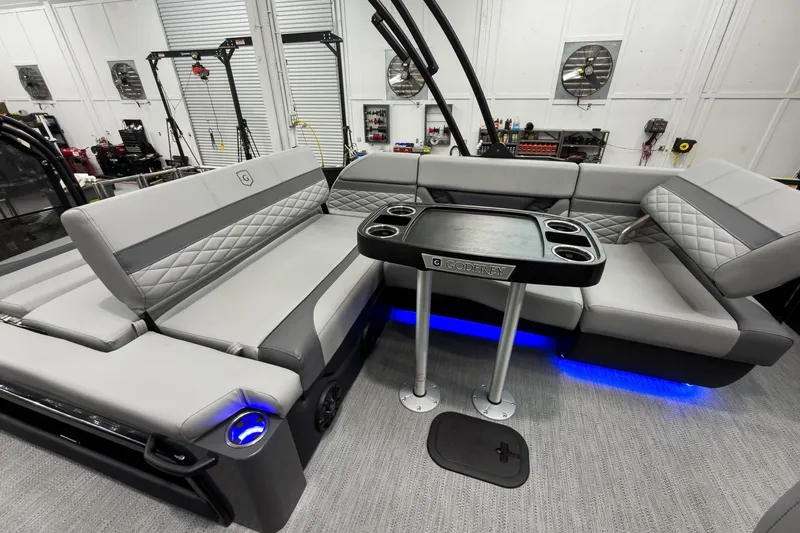 Slide: The Image of Luxurious interior of 2026 Godfrey Monaco 23' Tritoon with stylish seating and table. - 32