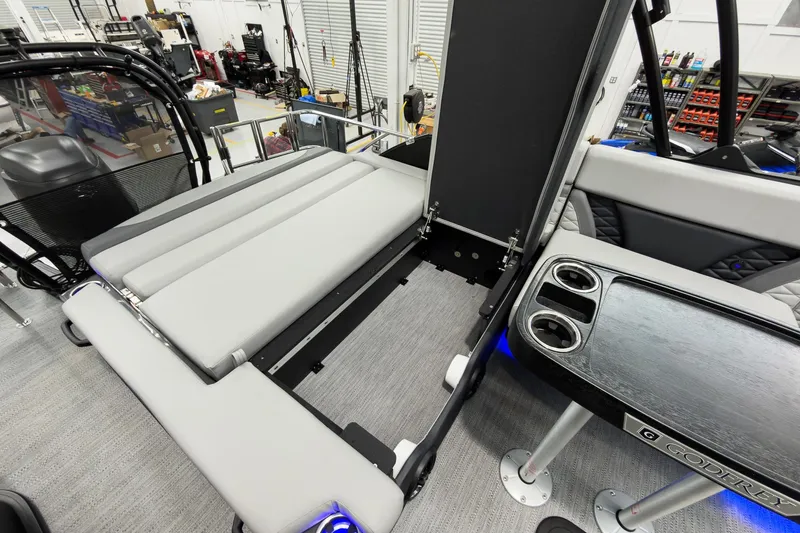 Slide: The Image of 2026 Godfrey Monaco 23' Tritoon with flip lounge, cup holders, and modern interior design. - 43