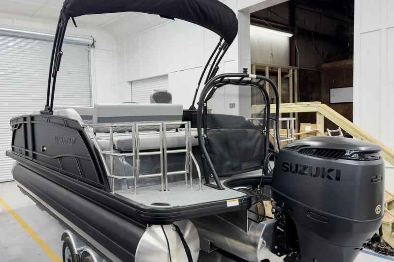 Slide: The Image of 2026 Godfrey Monaco 23' Tritoon with Suzuki engine in a showroom setting. - 9