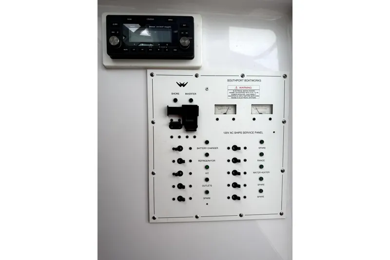 Slide: The Image of Cozy cabin interior of 2008 Southport 28 Express with cushioned seating and pillows. - 11