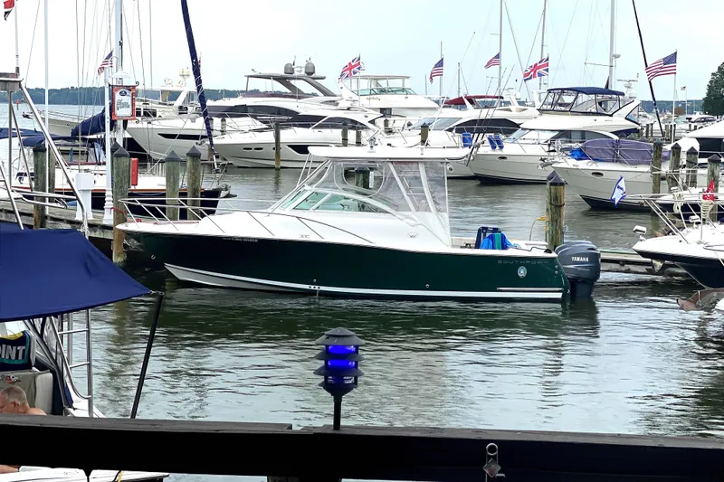 Slide: The Image of 2008 Southport 28 Express boat docked, aerial view, with twin engines and spacious deck. - 2