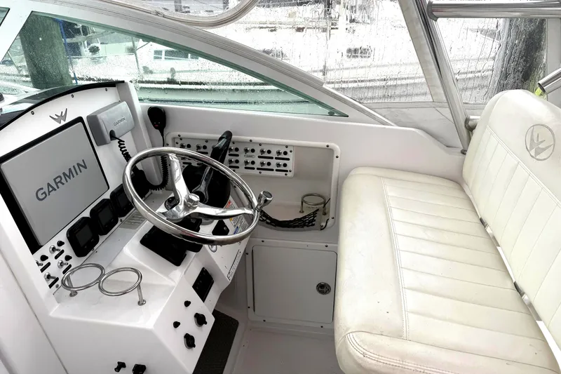 Slide: The Image of 2008 Southport 28 Express boat docked with twin 250 engines, marina background. - 4