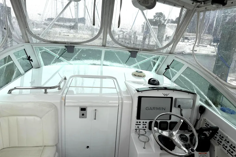 Slide: The Image of 2008 Southport 28 Express boat cockpit with Garmin navigation system and white seating. - 7