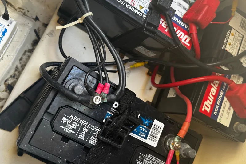 Slide: The Image of Marine batteries in a 2007 Parker 2520 XLD Sport Cabin boat, showing wiring connections. - 13