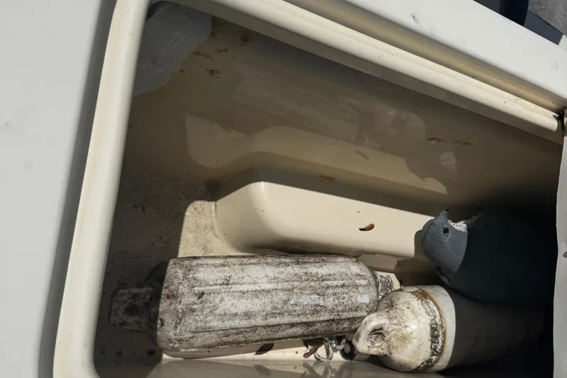 Slide: The Image of Storage compartment of 2007 Parker 2520 XLD Sport Cabin with boat fenders. - 15