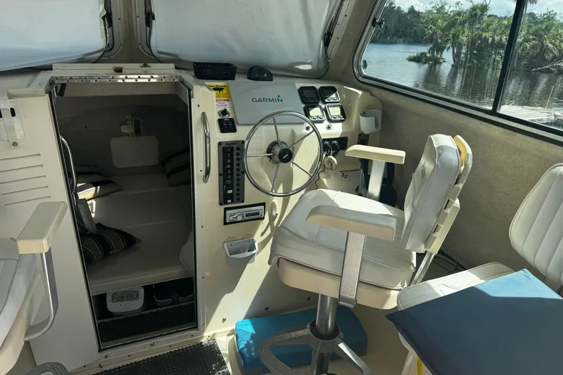 Slide: The Image of 2007 Parker 2520 XLD Sport Cabin interior with steering wheel and seating. - 6