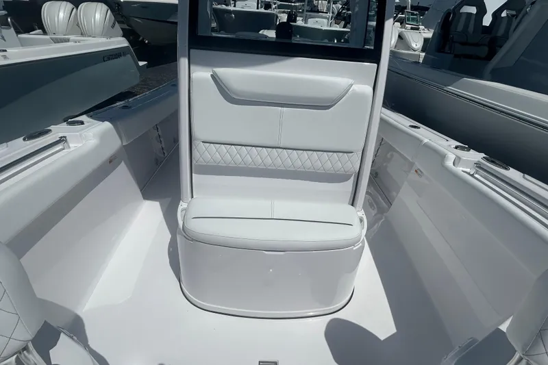 Slide: The Image of 2025 Sportsman Heritage 231 Center Console boat interior with white seating and modern design. - 15