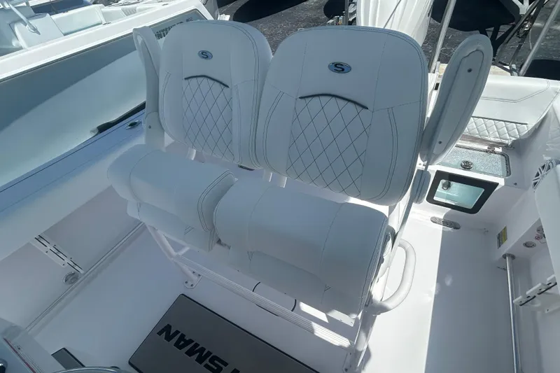 Slide: The Image of 2025 Sportsman Heritage 231 Center Console boat with white cushioned seating. - 16