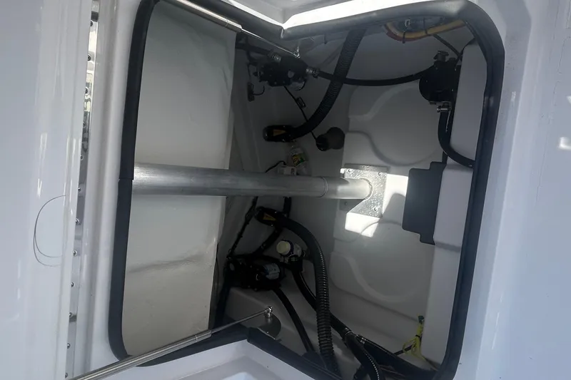 Slide: The Image of 2025 Sportsman Heritage 231 Center Console interior compartment with visible wiring and components. - 18