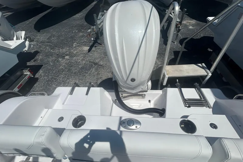 Slide: The Image of 2025 Sportsman Heritage 231 Center Console boat with outboard motor and seating area. - 19