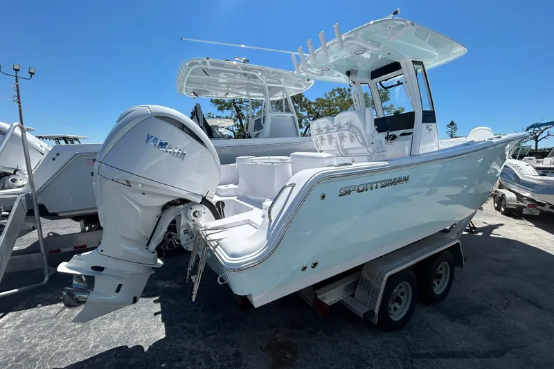 Slide: The Image of 2025 Sportsman Heritage 231 Center Console boat with Yamaha engine on trailer. - 2