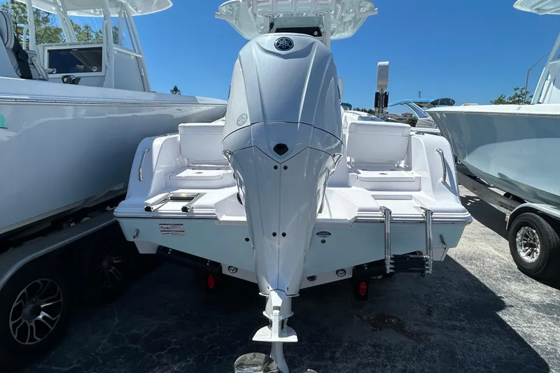 Slide: The Image of 2025 Sportsman Heritage 231 Center Console boat, rear view, showcasing sleek design and powerful engine. - 3