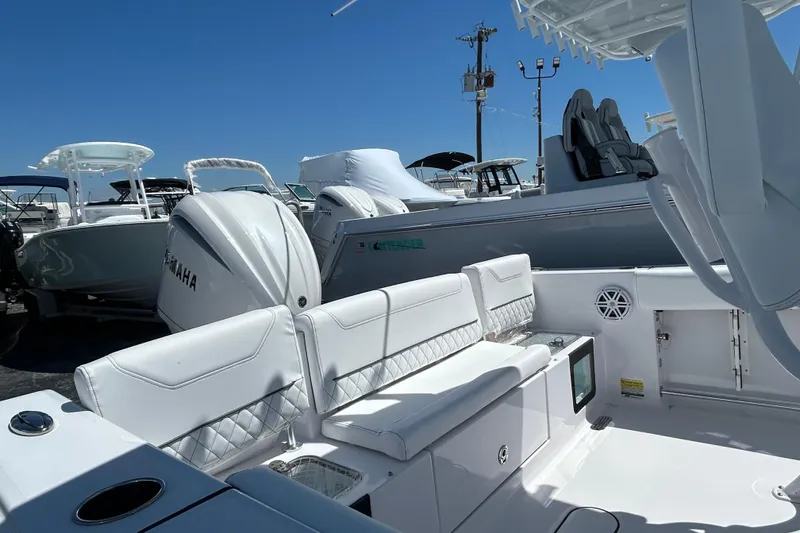 Slide: The Image of 2025 Sportsman Heritage 231 Center Console boat with Yamaha engine, featuring white seating and console. - 6