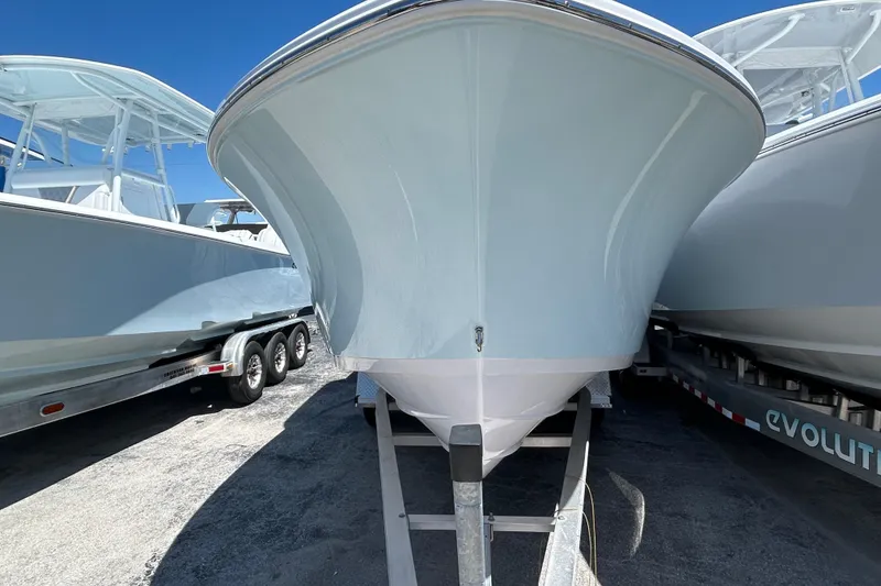 Slide: The Image of 2025 Sportsman Heritage 231 Center Console boat on trailer, front view. - 8
