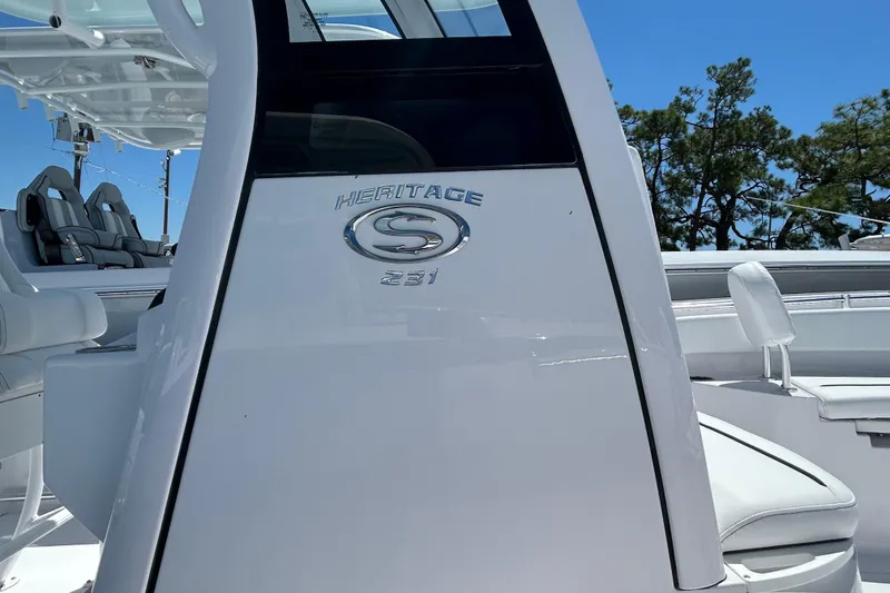 Slide: The Image of 2025 Sportsman Heritage 231 Center Console boat, sleek design, white finish, outdoor setting. - 9
