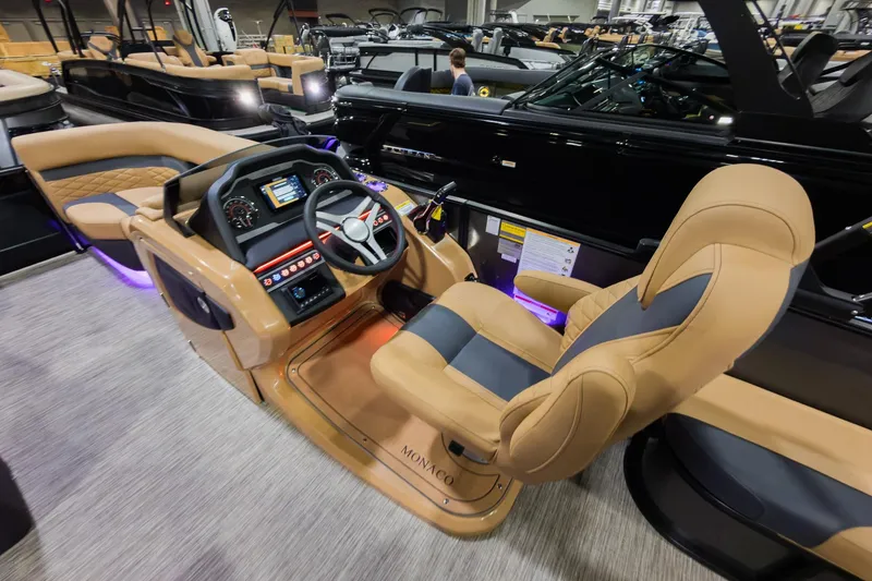 Slide: The Image of 2026 Godfrey Monaco 235 boat interior with luxurious seating and modern dashboard controls. - 13