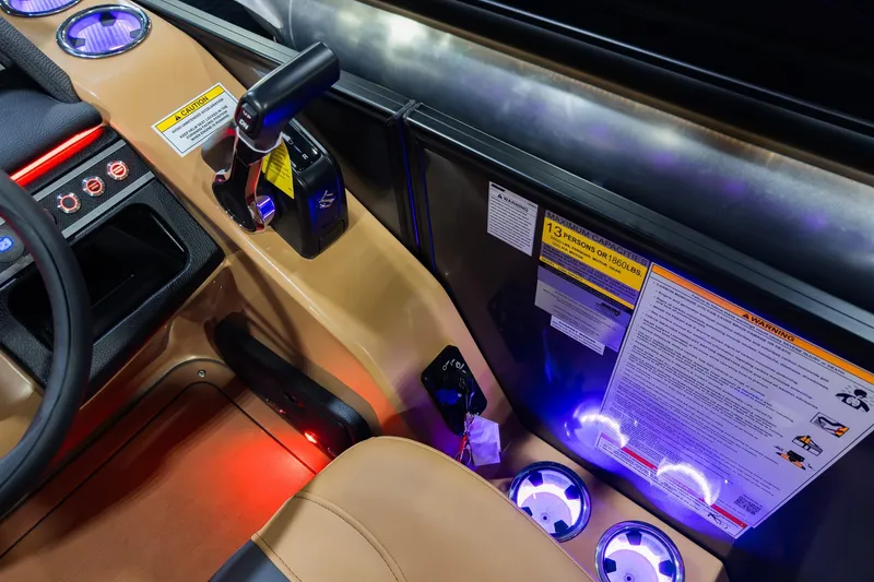 Slide: The Image of Interior of 2026 Godfrey Monaco 235 boat, featuring controls and illuminated cup holders. - 16