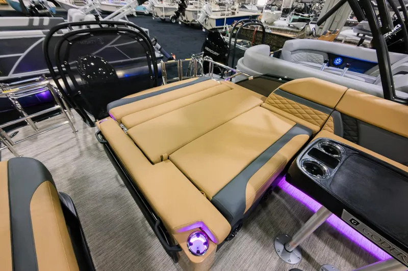 Slide: The Image of 2026 Godfrey Monaco 235 SFL boat with luxurious tan seating and ambient lighting. - 25